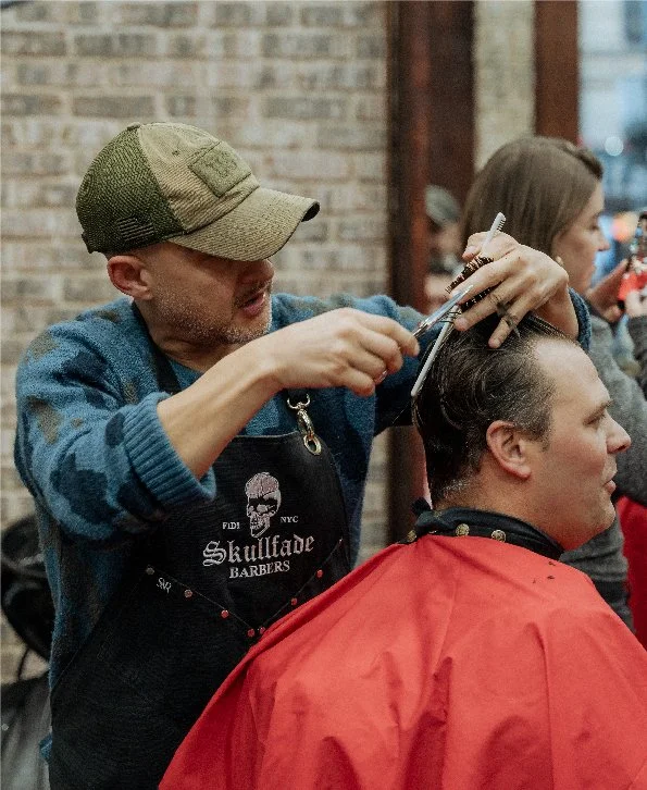 Skullfade barber performing a skin fade and line-up in NYC's Financial District